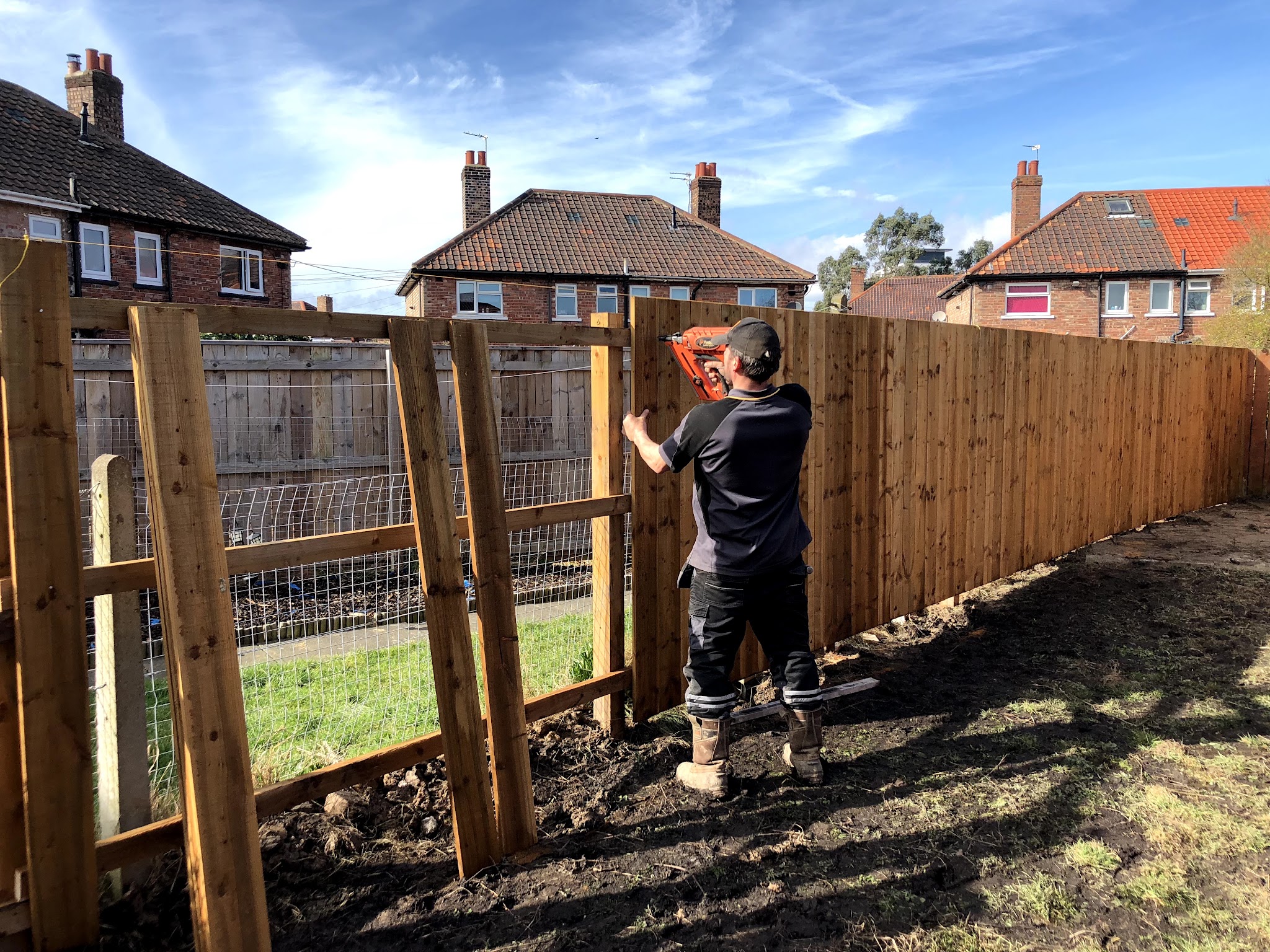 One of the team erecting a new close board fence