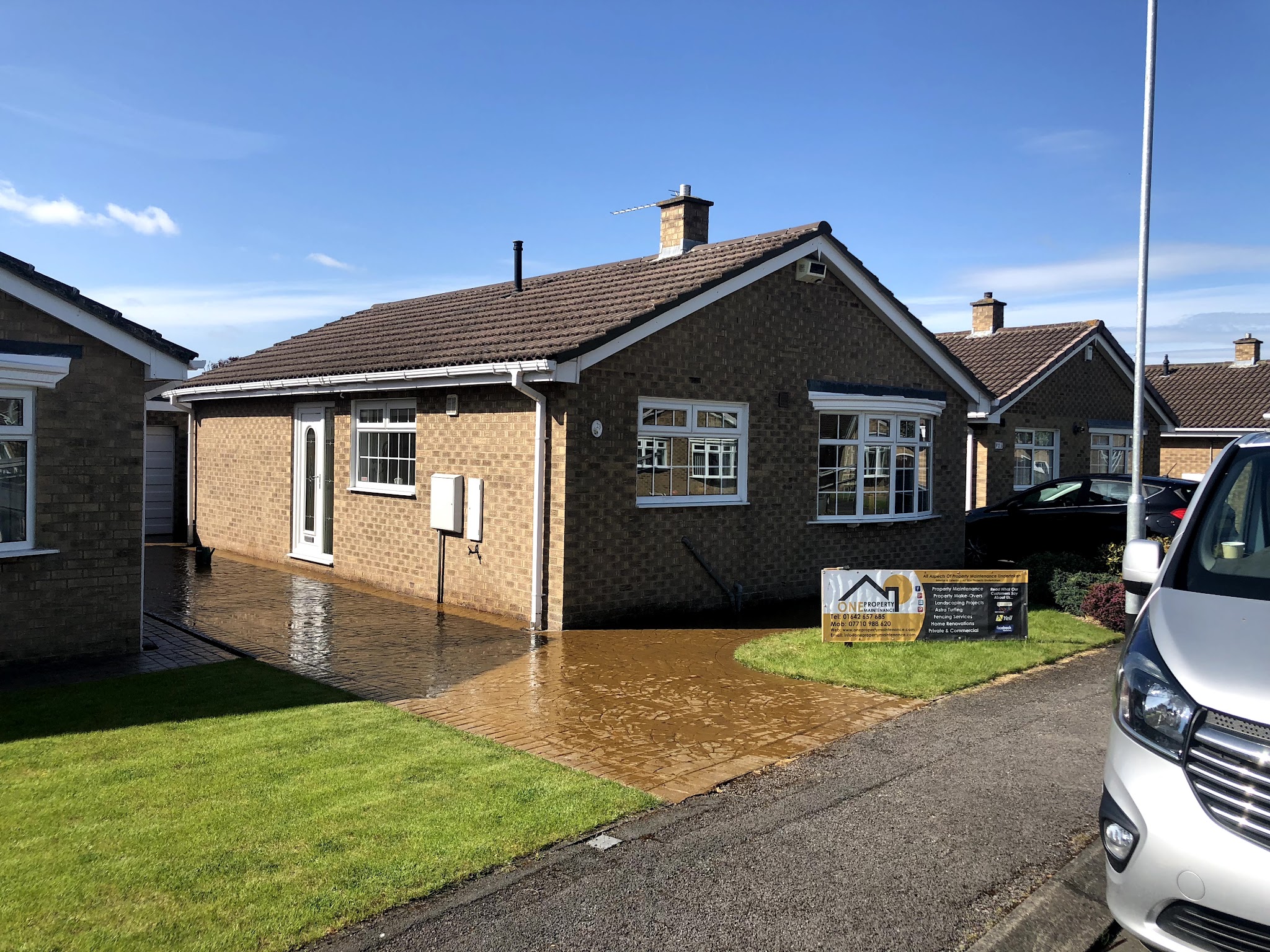 Bungalow with a freshly laid block paved driveway and the company sign in the front garden